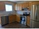 Updated kitchen with stainless steel appliances, granite countertops, and wood cabinets at 15703 E 13Th Pl, Aurora, CO 80011