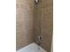 Tiled shower featuring adjustable shower head and updated fixtures at 15703 E 13Th Pl, Aurora, CO 80011