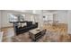 Finished basement area with sleek wood flooring, windows, and comfortable seating at 6425 Tremolite Dr, Castle Rock, CO 80108
