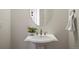 Bathroom featuring pedestal sink, decorative mirror, and neutral design at 6425 Tremolite Dr, Castle Rock, CO 80108