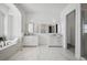 Luxurious bathroom with double vanities, soaking tub, and marble flooring at 6425 Tremolite Dr, Castle Rock, CO 80108