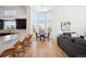 Bright breakfast nook with large windows offering a view, adjacent to a modern kitchen and living area at 6425 Tremolite Dr, Castle Rock, CO 80108