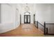 Expansive foyer featuring hardwood floors, high ceilings, and a staircase leading to the upper level at 6425 Tremolite Dr, Castle Rock, CO 80108
