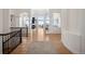 Bright foyer with wood floors and staircase flowing into a spacious living area with high ceilings and fireplace at 6425 Tremolite Dr, Castle Rock, CO 80108