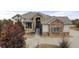 Elegant home with a stone and stucco facade, mature landscaping, and a grand entrance at 6425 Tremolite Dr, Castle Rock, CO 80108
