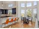 Bright eat-in kitchen with large windows, breakfast bar, and wood floors at 6425 Tremolite Dr, Castle Rock, CO 80108