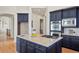 Kitchen featuring an island, stainless appliances, custom cabinets and light countertops at 6425 Tremolite Dr, Castle Rock, CO 80108