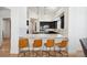 Open kitchen with breakfast bar and sleek, modern design at 6425 Tremolite Dr, Castle Rock, CO 80108