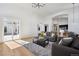 Bright living room featuring hardwood floors, archways, modern furnishings, and sliding glass door to a deck at 6425 Tremolite Dr, Castle Rock, CO 80108