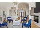 Living room with modern lighting and fireplace, featuring arched doorways and pillars at 6425 Tremolite Dr, Castle Rock, CO 80108