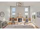 Spacious living room with a fireplace, hardwood floors and natural light at 6425 Tremolite Dr, Castle Rock, CO 80108