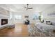 Light filled main bedroom boasts a fireplace, hardwood floors, an area rug, and a seating area at 6425 Tremolite Dr, Castle Rock, CO 80108