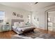 Spacious main bedroom with hardwood floors, light gray walls, and plenty of sunlight at 6425 Tremolite Dr, Castle Rock, CO 80108