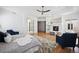 Spacious main bedroom featuring a fireplace, hardwood floors, a seating area and a ceiling fan at 6425 Tremolite Dr, Castle Rock, CO 80108