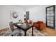 Modern office featuring hardwood floors, a desk, two accent chairs, an area rug and a decorative painting at 6425 Tremolite Dr, Castle Rock, CO 80108
