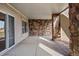 Covered patio enhanced by stone accents, offering a cool and stylish outdoor retreat at 6425 Tremolite Dr, Castle Rock, CO 80108