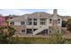 Exterior rear view features a multilevel deck, stone accents, and extensive windows at 6425 Tremolite Dr, Castle Rock, CO 80108