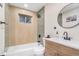 Updated bathroom featuring tiled walls, modern fixtures, and a stylish vanity at 1240 S Chase Ct, Lakewood, CO 80232