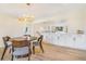 Stylish dining room with modern light fixture, round table, and access to the kitchen at 1240 S Chase Ct, Lakewood, CO 80232