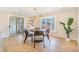 Bright dining room featuring a modern light fixture, bay window, and sliding glass doors at 1240 S Chase Ct, Lakewood, CO 80232