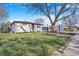 Beautiful home with a well-maintained lawn, mature trees, and attractive curb appeal at 1240 S Chase Ct, Lakewood, CO 80232