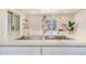 Bright view of a kitchen sink, faucet, and countertops with a pendant light at 1240 S Chase Ct, Lakewood, CO 80232