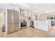 Bright kitchen with stainless steel appliances, white cabinetry, and modern countertops at 1240 S Chase Ct, Lakewood, CO 80232
