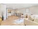 Spacious living room featuring light hardwood floors, modern furniture, and an open floor plan at 1240 S Chase Ct, Lakewood, CO 80232