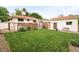 Large backyard features a deck, a lush green lawn, storage shed, and a fence creating a private outdoor space at 5885 S Huron St, Littleton, CO 80120