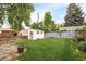 Large backyard featuring a grassy area, white storage shed and wood fence at 5885 S Huron St, Littleton, CO 80120