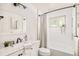 Well-lit bathroom with white tile, a shower-tub combo, and stylish vanity with marble countertop at 5885 S Huron St, Littleton, CO 80120