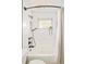 Bathroom features white tile, shower-tub combo, and dark hardware at 5885 S Huron St, Littleton, CO 80120