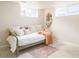 Cozy bedroom with daybed, soft textures, and bright natural light from windows at 5885 S Huron St, Littleton, CO 80120