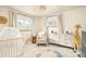 Bright Bedroom featuring neutral decor, comfortable rocker, and animal-themed accents at 5885 S Huron St, Littleton, CO 80120