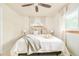 Comfortable bedroom featuring a ceiling fan, and two windows with neutral decor at 5885 S Huron St, Littleton, CO 80120