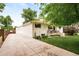 Charming home exterior with a long driveway, manicured lawn, and blooming flower beds, offering great curb appeal at 5885 S Huron St, Littleton, CO 80120