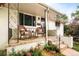 Inviting front porch with comfortable wicker seating and decorative flowers adding charm to the home's entrance at 5885 S Huron St, Littleton, CO 80120