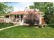 Charming, white-painted home with a red roof, covered porch and meticulous landscaping at 5885 S Huron St, Littleton, CO 80120