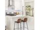 Bright, white kitchen with breakfast bar and sleek appliances at 5885 S Huron St, Littleton, CO 80120