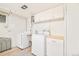 Functional laundry room with washer, dryer, and ample storage cabinets at 5885 S Huron St, Littleton, CO 80120
