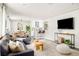 Open concept living room featuring modern furnishings that flow into dining and kitchen areas at 5885 S Huron St, Littleton, CO 80120