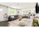 Open-concept living space with hardwood floors, leading into the dining area and kitchen at 5885 S Huron St, Littleton, CO 80120