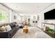 Modern living room seamlessly connects to a dining area and sleek white kitchen at 5885 S Huron St, Littleton, CO 80120