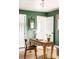 Stylish home office with green walls, wooden desk, and bright white trim at 5885 S Huron St, Littleton, CO 80120