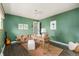 Inviting home office with green walls, decorative desk, and ample natural light at 5885 S Huron St, Littleton, CO 80120