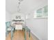 The shed interior is finished with white walls and wood look floors plus a dining area at 5885 S Huron St, Littleton, CO 80120