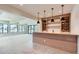 Basement bar area with custom cabinetry and a wine rack at 5820 Powell Rd, Parker, CO 80134