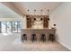 Basement wet bar featuring a wine rack and four barstools at 5820 Powell Rd, Parker, CO 80134