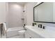 Modern basement bathroom with white vanity, bathtub, and shower at 5820 Powell Rd, Parker, CO 80134