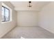 Well-lit basement bedroom with large window and neutral wall colors at 5820 Powell Rd, Parker, CO 80134